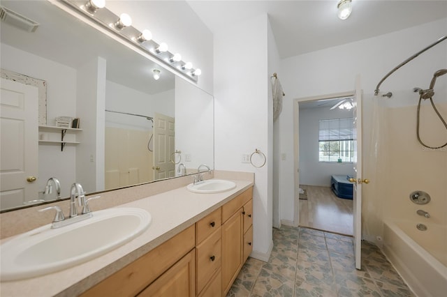 bathroom with shower / bath combination and vanity