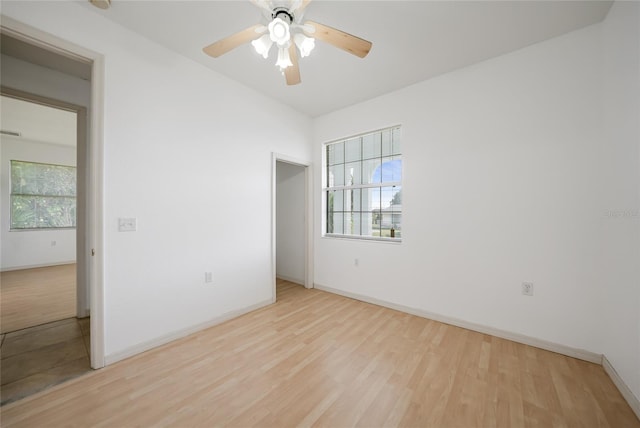 spare room with ceiling fan and light wood-type flooring