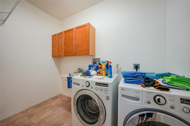 washroom featuring cabinets and independent washer and dryer