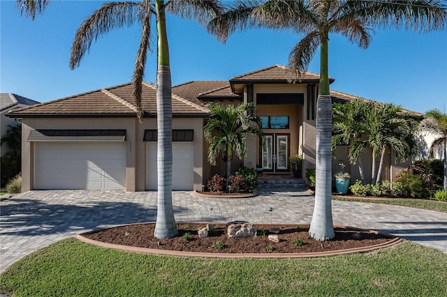 view of front of home with a garage and french doors