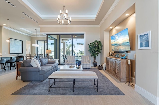 living room with a raised ceiling, a notable chandelier, and ornamental molding