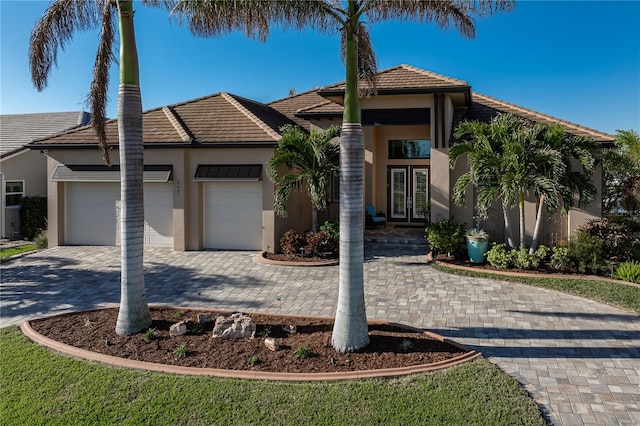 view of front of house with a garage and french doors