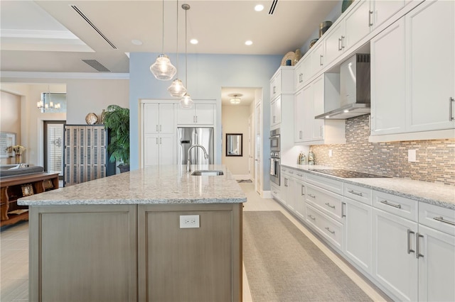 kitchen with a large island with sink, ventilation hood, and white cabinetry