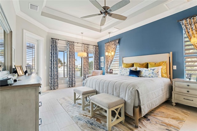 bedroom featuring a raised ceiling, ceiling fan, and crown molding