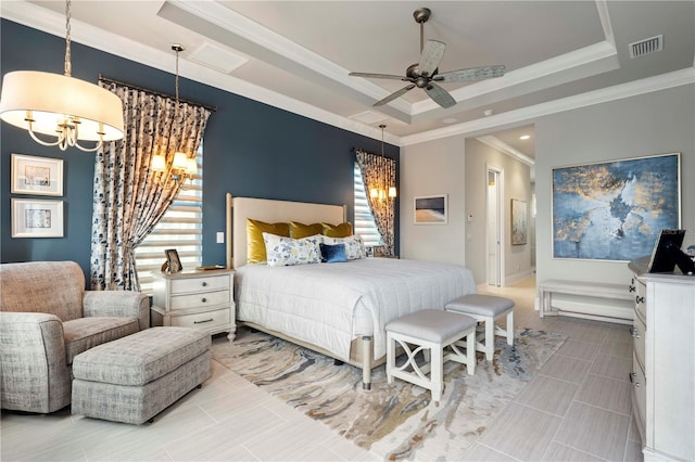 bedroom featuring ceiling fan with notable chandelier, a tray ceiling, and ornamental molding