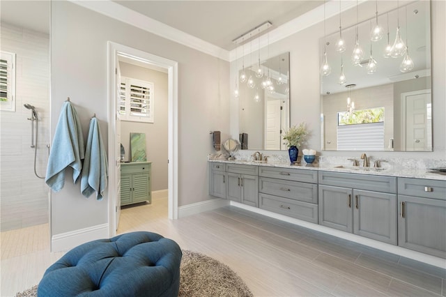 bathroom with a shower, vanity, and ornamental molding