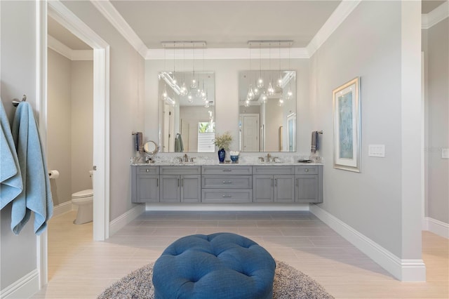 bathroom with tile patterned flooring, vanity, toilet, and ornamental molding