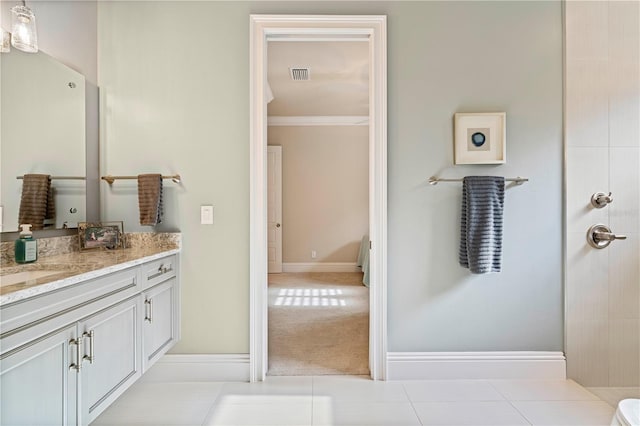 bathroom featuring tile patterned flooring, vanity, and ornamental molding