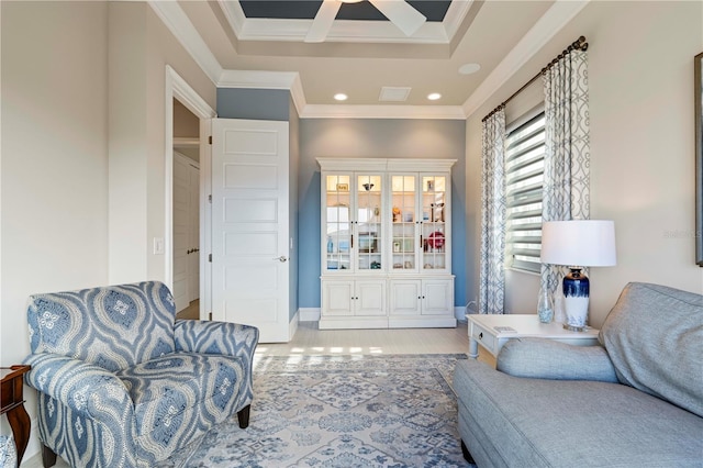 sitting room featuring ceiling fan, light wood-type flooring, and crown molding