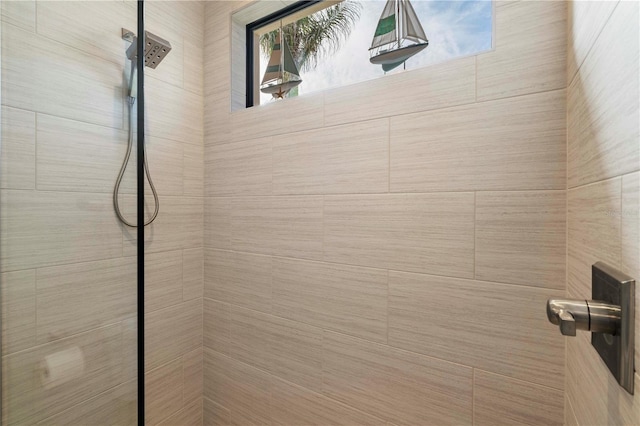 interior details featuring tiled shower