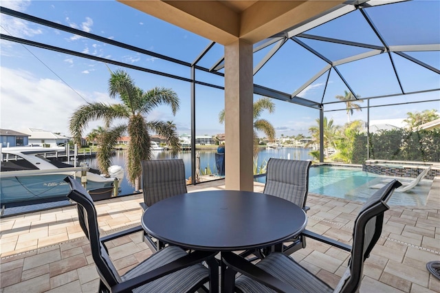 view of patio / terrace with glass enclosure and a water view