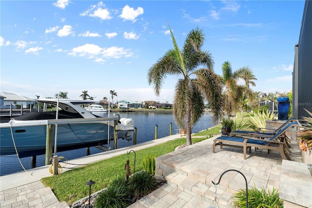 view of patio / terrace with a boat dock and a water view