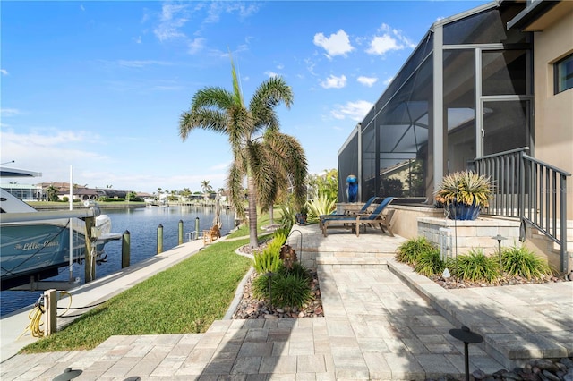 exterior space featuring a patio, a water view, a dock, and a lanai