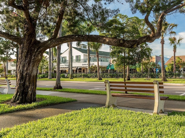 view of home's community with a lawn and fence