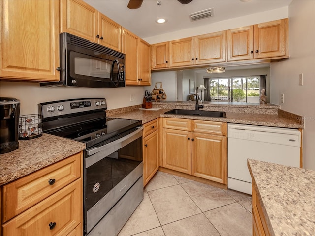 kitchen with black microwave, a sink, visible vents, dishwasher, and stainless steel range with electric stovetop