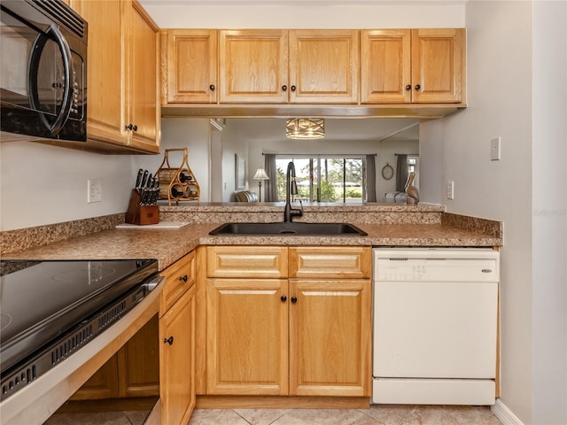 kitchen with dishwasher, stainless steel electric range oven, light countertops, black microwave, and a sink