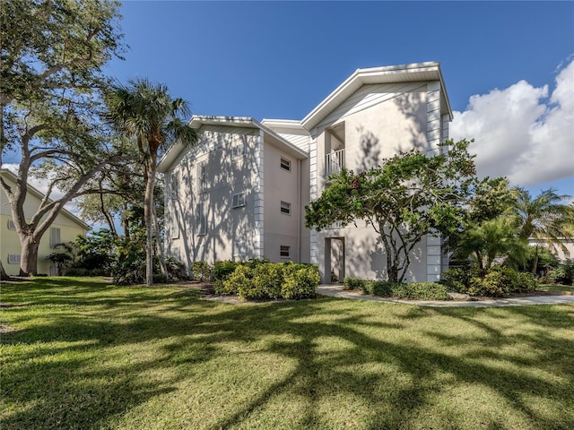 view of property exterior featuring a lawn