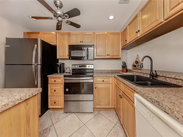 kitchen featuring ceiling fan, light brown cabinetry, appliances with stainless steel finishes, and a sink