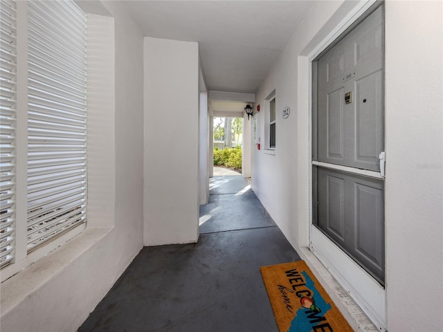 hall featuring concrete flooring