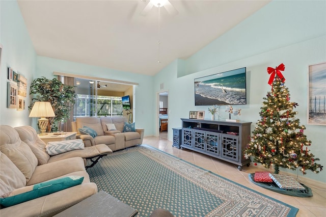 living room with ceiling fan, light tile patterned flooring, and vaulted ceiling