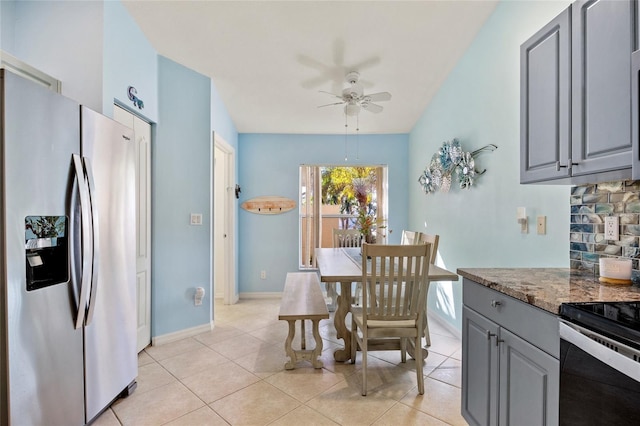 tiled dining space with ceiling fan