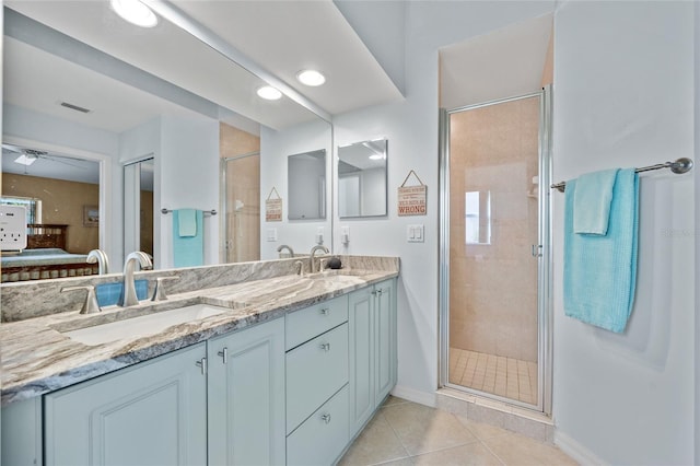 bathroom featuring tile patterned flooring, vanity, and a shower with door