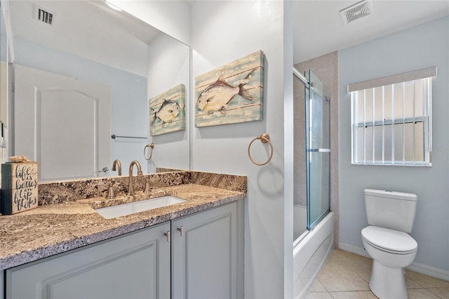 full bathroom with tile patterned flooring, vanity, toilet, and combined bath / shower with glass door