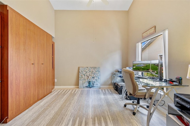 office area with ceiling fan and light hardwood / wood-style flooring