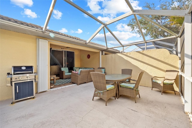 view of patio / terrace featuring outdoor lounge area, glass enclosure, and grilling area