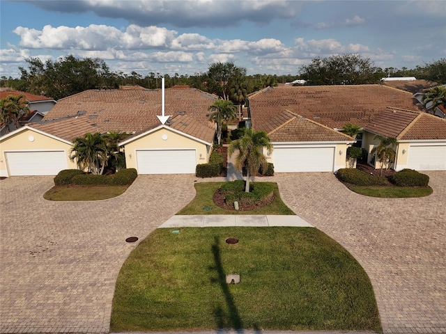 view of front of house with a garage and a front lawn