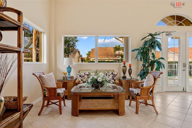 living area featuring light tile patterned flooring and a high ceiling