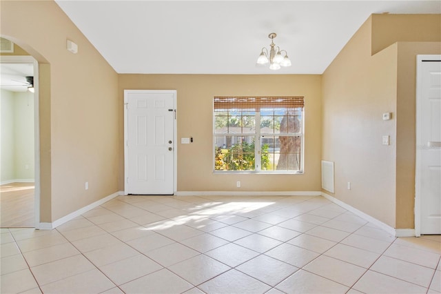 tiled foyer with ceiling fan with notable chandelier and vaulted ceiling