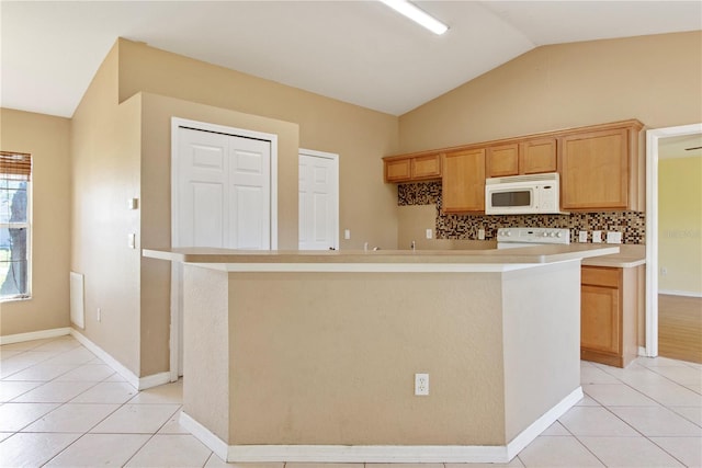 kitchen with decorative backsplash, stove, light tile patterned floors, and lofted ceiling