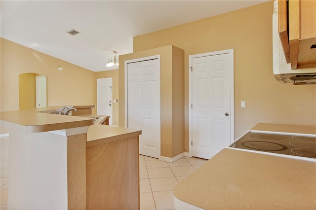 kitchen featuring sink, an inviting chandelier, pendant lighting, light brown cabinetry, and light tile patterned floors