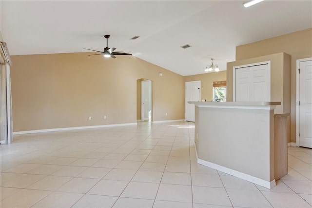 interior space with ceiling fan with notable chandelier and vaulted ceiling