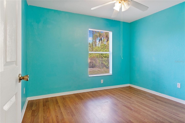 unfurnished room with ceiling fan and hardwood / wood-style floors