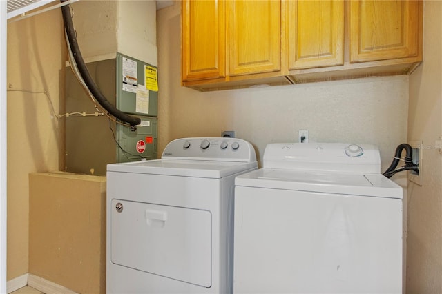 washroom featuring separate washer and dryer and cabinets