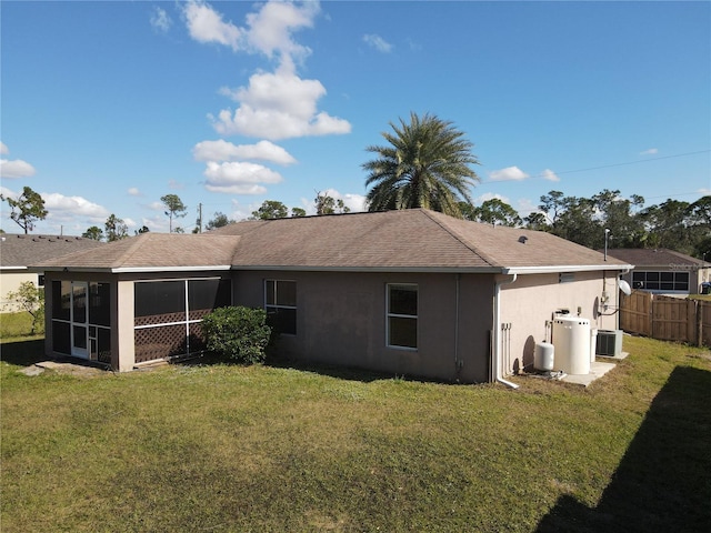 back of house featuring a yard, central AC, and a sunroom