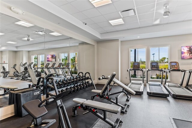 exercise room featuring a paneled ceiling and ceiling fan