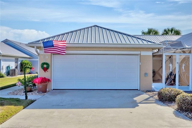 view of front facade with a lanai, central AC unit, and a garage