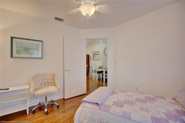 bedroom with hardwood / wood-style floors and ceiling fan