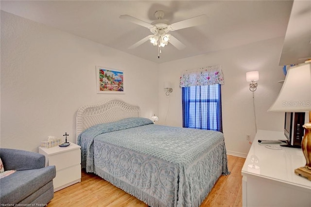 bedroom with ceiling fan and light hardwood / wood-style floors