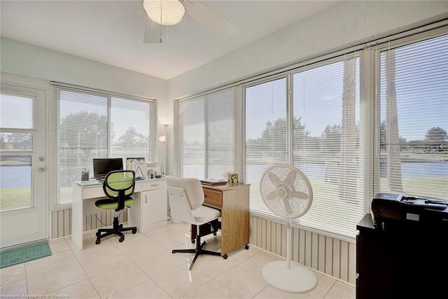 office with light tile patterned floors, a water view, and ceiling fan