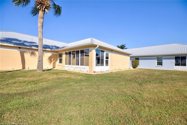 rear view of house with a yard