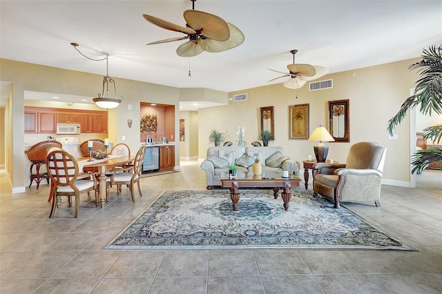 tiled living room featuring ceiling fan