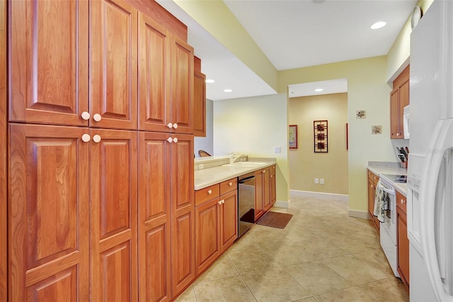 kitchen featuring sink, light tile patterned floors, and white appliances