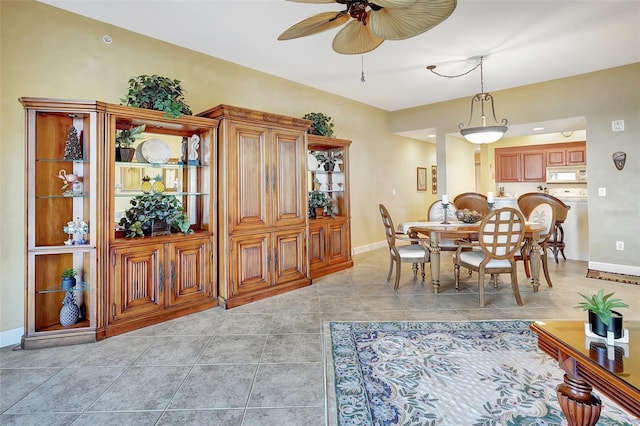 tiled dining space featuring ceiling fan