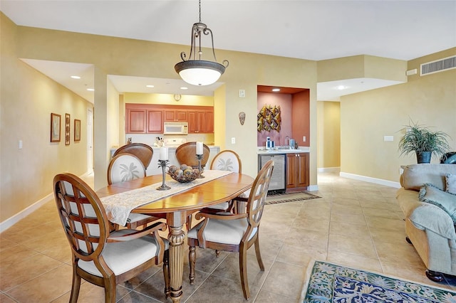 dining space with light tile patterned floors and beverage cooler