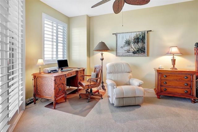 carpeted home office featuring ceiling fan