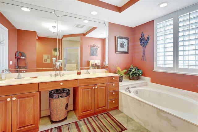 bathroom with tile patterned floors, vanity, and shower with separate bathtub